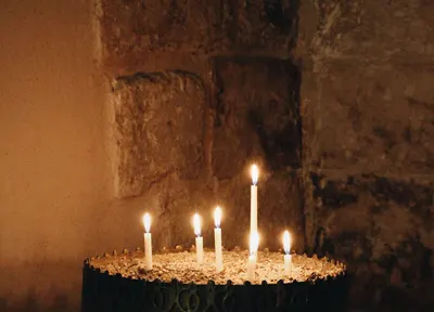 Candles burning in a quiet stone chapel of rest, R.C. Smallbone Funeral Directors Newbury