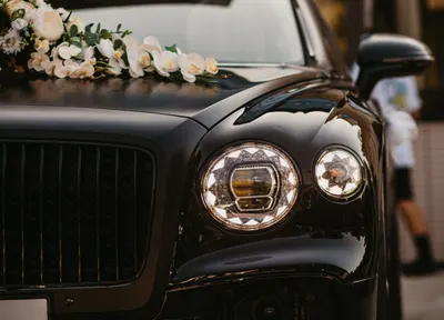 Funeral car dressed with white floral tributes, R.C. Smallbone Funeral Directors Newbury