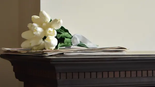 White flowers resting on a mantelpiece, feedback for R.C. Smallbone Funeral Directors Newbury