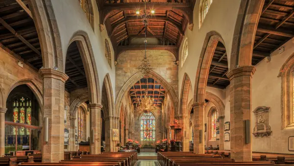 Interior of an English parish church with wooden pews, R.C. Smallbone Funeral Directors Newbury Berkshire
